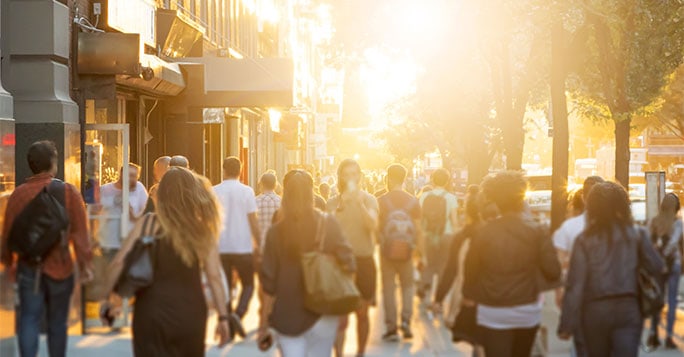 crowd of people in a sunny street