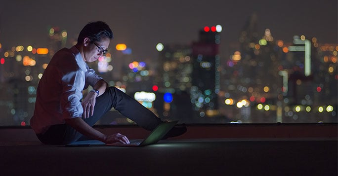 woman using laptop on a rooftop