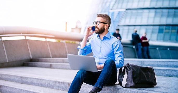 man sat on stairs with laptop