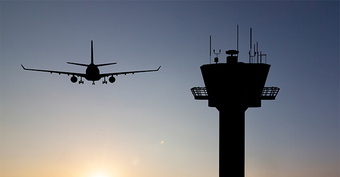 Silhouette of plane and control centre