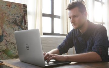 man working on Dell laptop